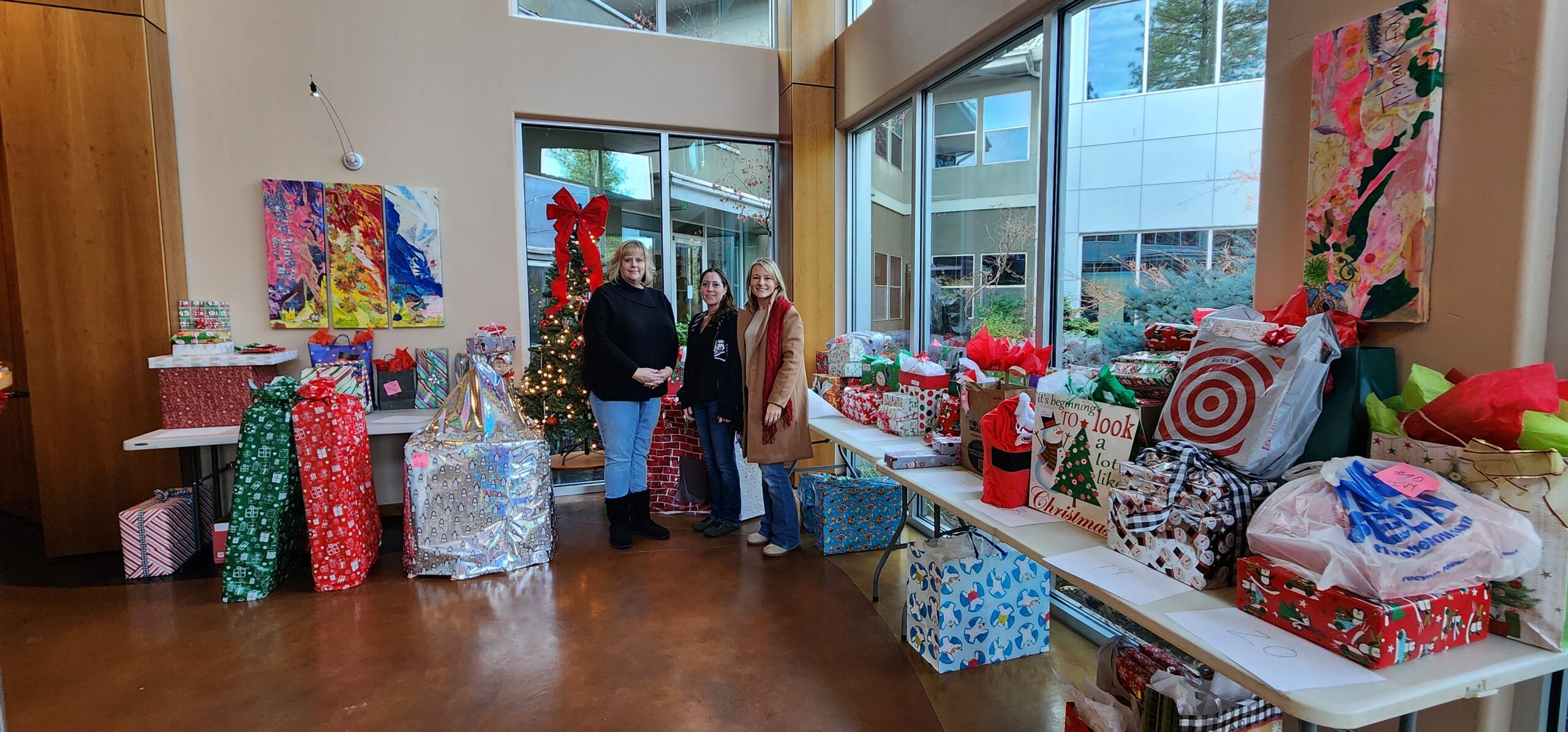 Alisa Johnson and her team with the presents donated to the kids on the Angel Tree